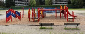 blue and red playground on woodchip surfacing