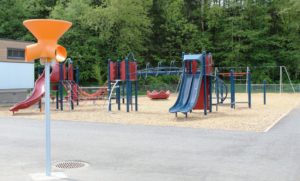 red silver and blue playground on woodchip surfacing