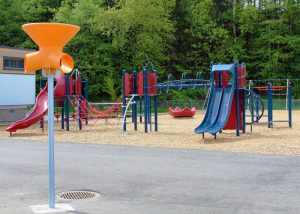 red and blue playground on woodchip surfacing