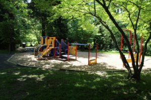 red yellow and blue playground on woodchip surfacing