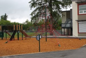 brown and green playground on woodchip surfacing