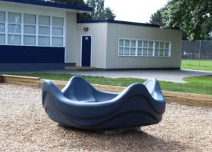 blue and green playground on woodchip surfacing