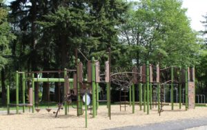 green and brown playground on woodchip surfacing