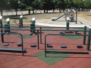 outdoor fitness equipment on red rubber surfacing