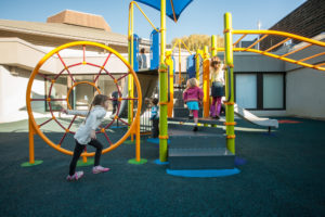 blue and green playground on rubber surfacing