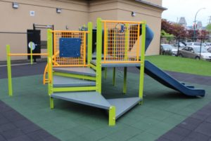 green and blue playground on rubber surfacing