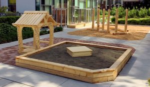 YMCA Natural Play sandbox and play house