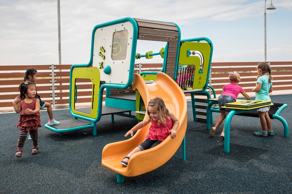 girls sliding and playing on playground