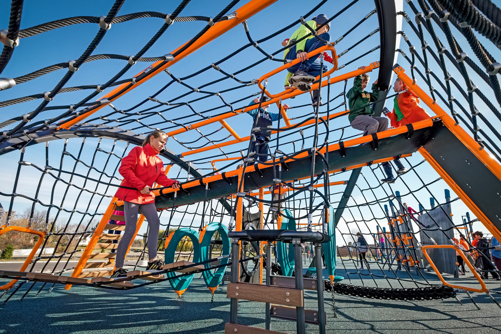 older kids climbing on playground net