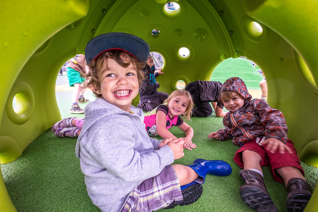 children smiling in playground dome