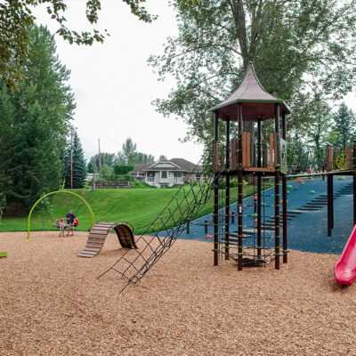 playground on a hillside with climbing nets and slide