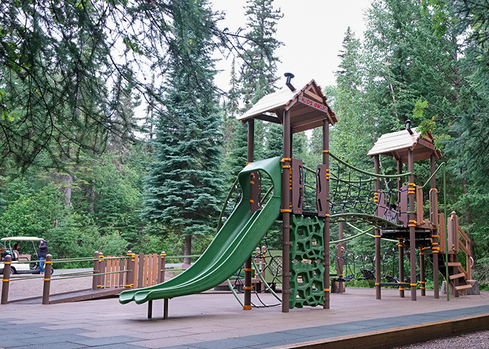 Green and brown playground in the woods