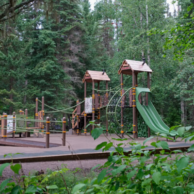 Green and brown playground in the woods