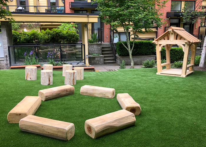 Play area with Log seats, logs circle, and a playhouse