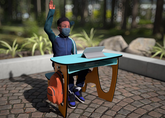 children sitting in outdoor desks