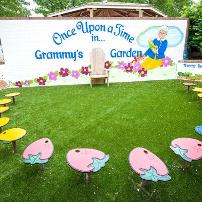 Outdoor classroom with a mural and fruit shaped seats