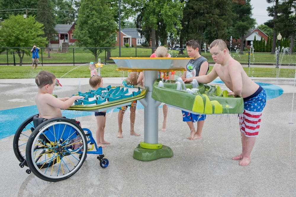 a splash pad design with children playing at a water table