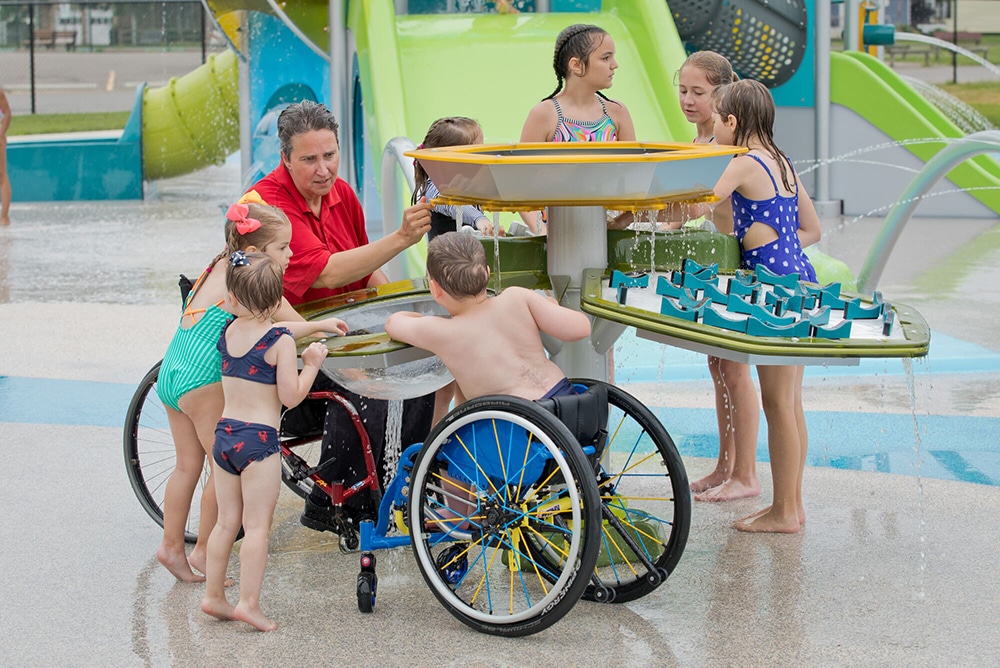 Inclusive Playground Design expert Ingrid Kanics testing a water table