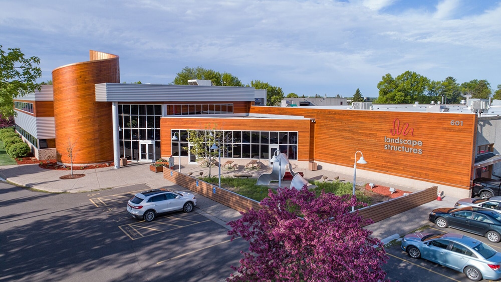 modern office building with Landscape Structures playground design logo and wood exterior