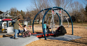 a child being rolled to a wheelchair swing