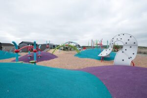 colourful playground on mounded poured-in-place rubber surfacing