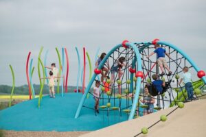 colourful playground on mounded poured-in-place rubber surfacing