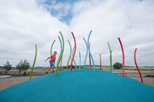 colourful playground on mounded poured-in-place rubber surfacing