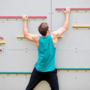 Man using fitness challenge wall