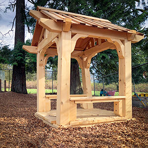 wooden playhouse on wood chip surfacing