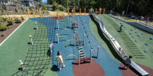 hillside playgrund at queenston park in coquitlam featuring nets and slides