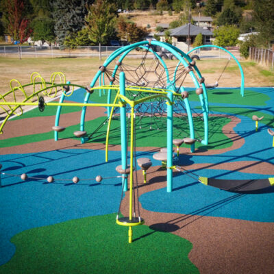 School playground with net climber and oodle swings