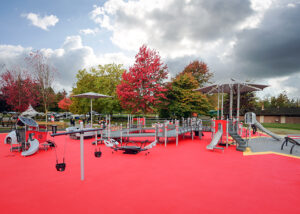 Grey playground on red rubber surfacing