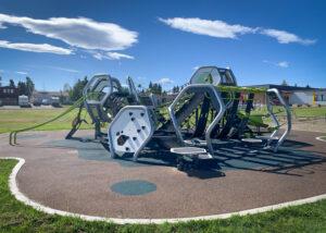 Futuristic silver and green playground on PIP rubber surfacing