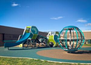 Futuristic blue, silver, and green playground on PIP rubber surfacing