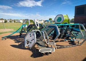 Futuristic blue, silver, and green playground on PIP rubber surfacing