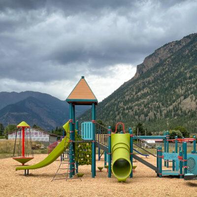 Blue, red, and green playground on wood fibre