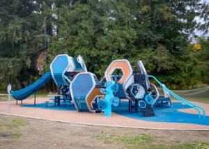 Futuristic blue, silver, and brown playground on PIP rubber surfacing