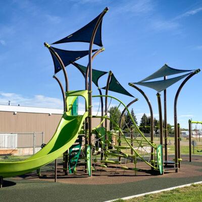 Photo of brown and green playground and swings on PIP rubber surfacing