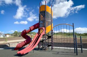 Red, yellow, and black playground on PIP rubber surfacing