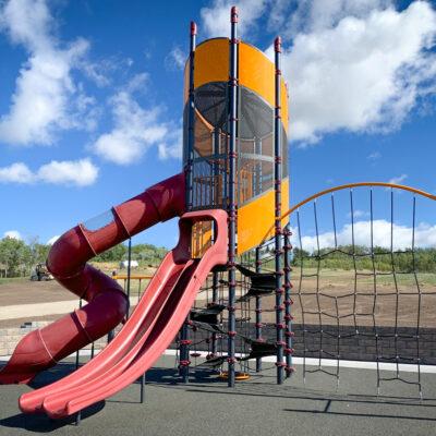 Red, yellow, and black playground on PIP rubber surfacing