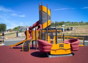Red, yellow, and black playground on PIP rubber surfacing