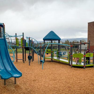 Frey, blue, and green playground on wood fibre with wheelchair ramp