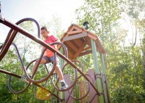 child on playground climber