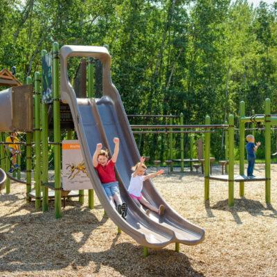 green and brown playground on woodchip surfacing