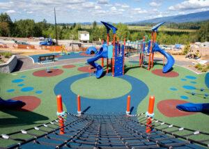blue and red playground with hill slides in the back