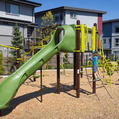 green and brown playground on woodchip surfacing