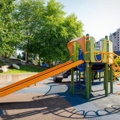 green and yellow playground on rubber surfacing