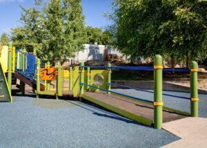 green and yellow playground on rubber surfacing
