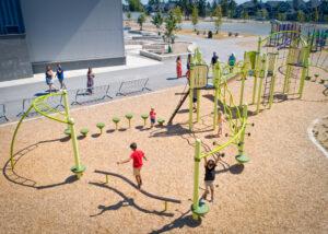 green and silver playground on woodchip surfacing