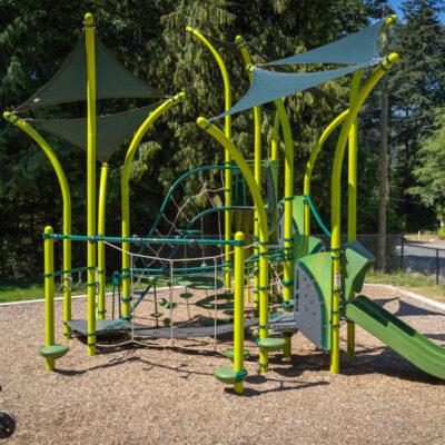 green playground on woodchip surfacing